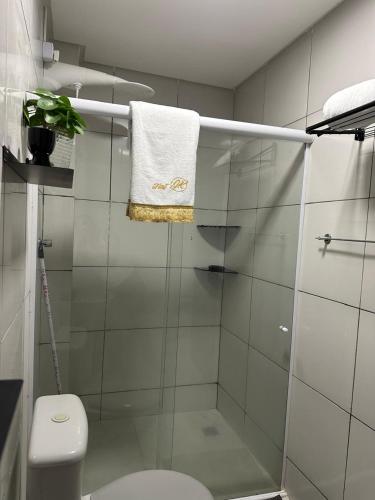a bathroom with a shower with a toilet and a towel at Flat JK 201 in Juazeiro do Norte