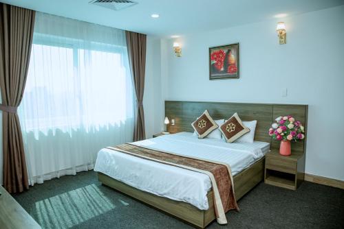 a bedroom with a large bed in a room at Nhà khách Bông Sen in Vinh
