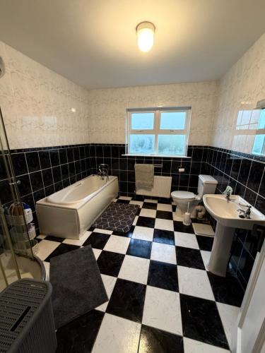 a bathroom with a black and white checkered floor at Trá Leathan in Doolin