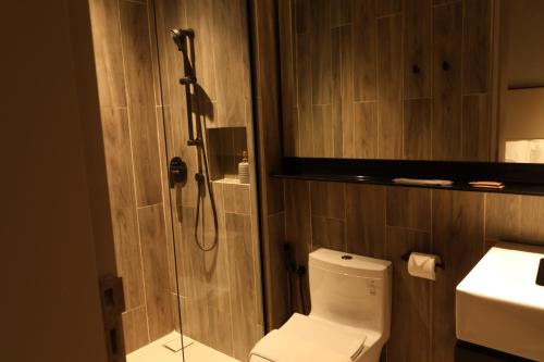 a bathroom with a shower and a toilet and a sink at Antara Genting Cozy Studio in Genting Highlands