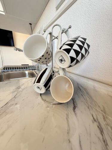 a pile of cups sitting on top of a kitchen counter at Private Loft Free Parking Pet friendly in Chapulco