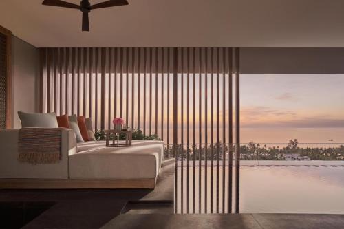 a bedroom with a bed and a view of the ocean at Regent Phu Quoc in Phú Quốc