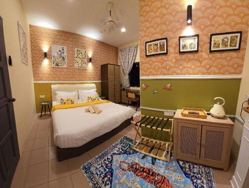 a bedroom with a bed and a table and a room with at KRS Pines GuestHouse in Cameron Highlands