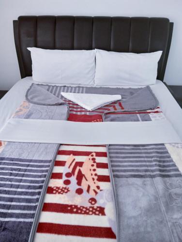 a bed with an american flag quilt on it at Moonlight Guest House in Johannesburg