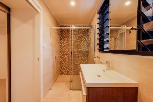 a bathroom with a shower and a sink at Mokum House Designer Escape with Pool Sauna in Brisbane