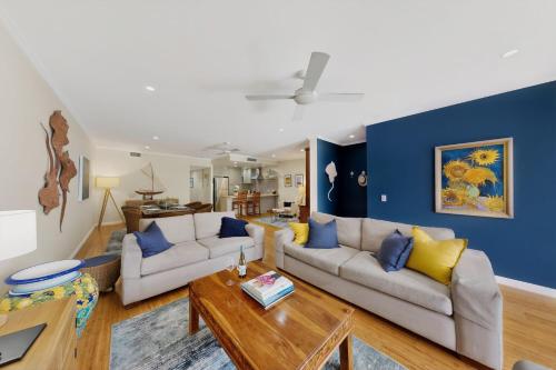 a living room with two couches and a table at Tidal Haven in Noosaville