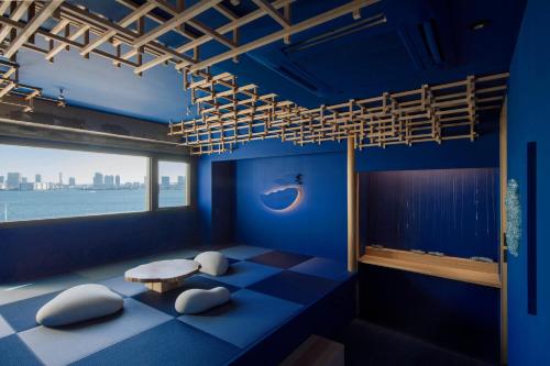 a blue room with a table and a window at Art House HINODE 10 people 3 minutes from the station Art and Tokyo Bay spectacular ocean view in Tokyo