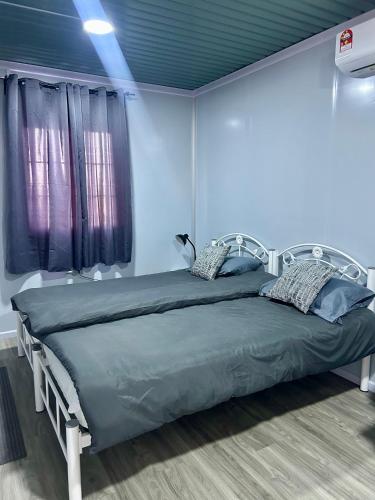 a bedroom with a bed in a room at TeeDo Zzz in Parit Buntar