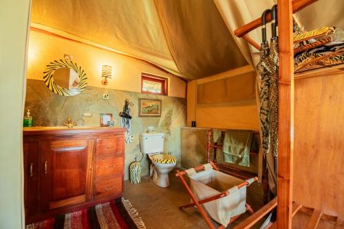 a bathroom with a toilet and a sink in a room at Buffalo's Rest Greenpark-Naivasha in Naivasha
