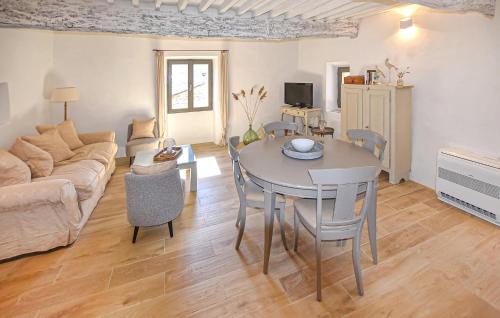 a living room with a table and a couch at Maison En Pierres in Rustrel
