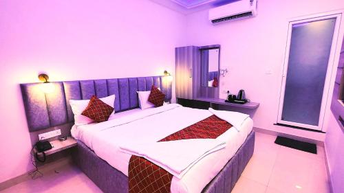 a bedroom with a large bed in a room at hotel Gautam Inn in Gorakhpur