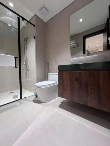 a bathroom with a toilet and a sink and a mirror at Moon Inn Apartment-self check in in Hanoi