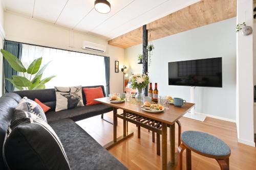 a living room with a couch and a table at INUYAMA BASE Vacation rental in Inuyama