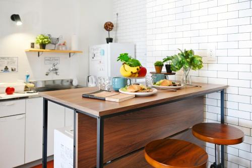 a kitchen with a table with a plate of food on it at INUYAMA BASE Vacation rental in Inuyama