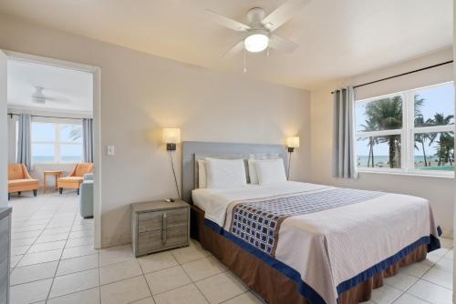 a bedroom with a bed and a room with a balcony at La Terrace Oceanfront in Hollywood