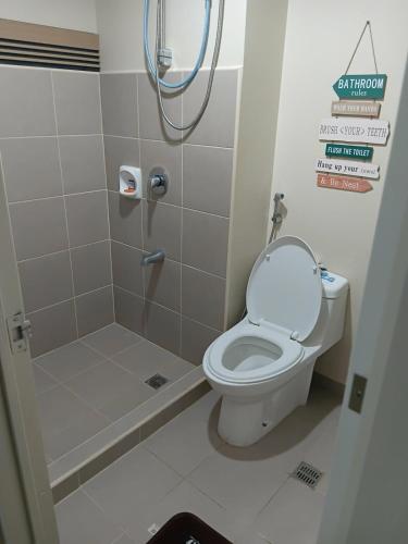 a bathroom with a toilet and a shower at Josephine's place at Avida Aspira Tower 2 CDO in Cagayan de Oro