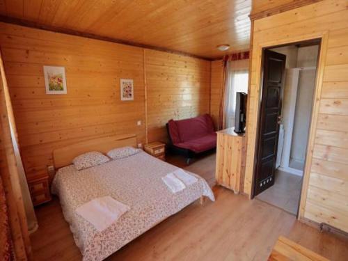 a bedroom with a bed and a television in it at Camping Valle de Hecho in Hecho