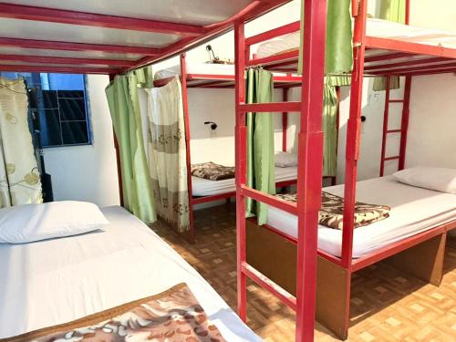 a room with three bunk beds and a bathroom at Vang Vieng Freedom View Hostel in Ban Khouaphan