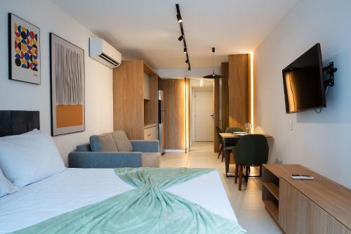 a bedroom with a bed and a living room at Skylux by Tegra in Rio de Janeiro