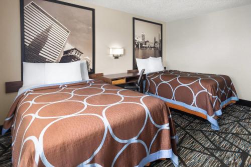 a hotel room with two beds next to each other at Super 8 by Wyndham Mentor/Cleveland Area in Mentor