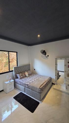 a bedroom with a large bed in a room at Villa Cascade in Akuressa