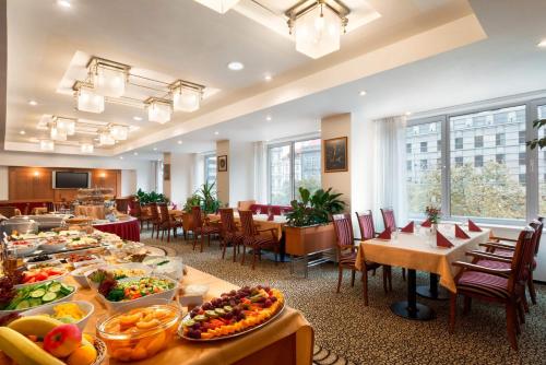 a dining room with a buffet of food on tables at Ramada Prague City Centre in Prague