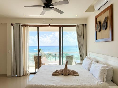 a bedroom with a bed with a view of the ocean at Grand Boréna Hotel Boutique in Playa del Carmen