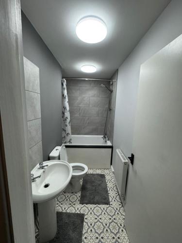 a small bathroom with a sink and a toilet at Stylish double room in Mansfield