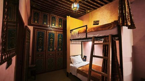 a bedroom with two bunk beds in a room at La Kasbah Salam Hostel in Fez