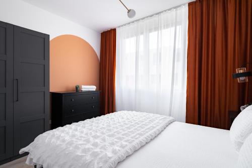 a bedroom with a white bed and a window at Sika Platinum Apartment - cazare premium Arad - self check-in in Arad