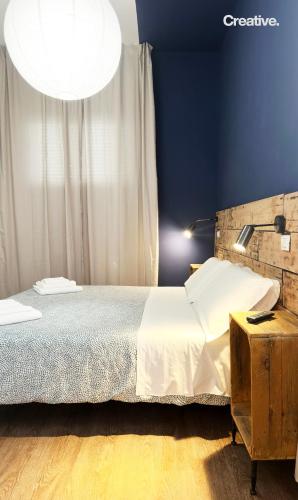 a bedroom with a bed and a lamp on a table at Hotel Nizza Creative Hotel in Rimini