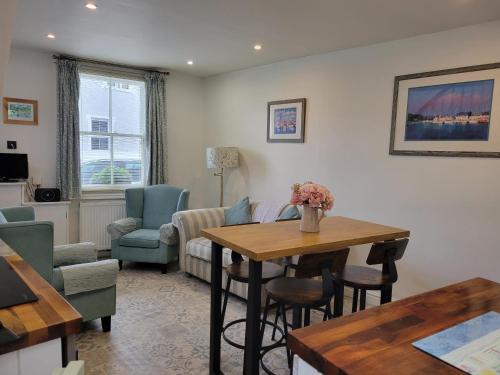 a living room with a table and chairs at Millgate Cottage in Conwy