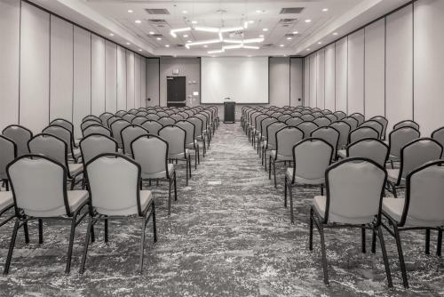 an empty conference room with chairs and a podium at Hilton Garden Inn Sioux Falls South in Sioux Falls