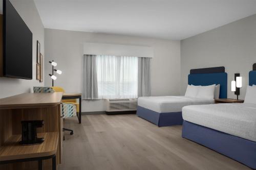a hotel room with a bed and a desk at Hampton Inn By Hilton Clanton in Clanton