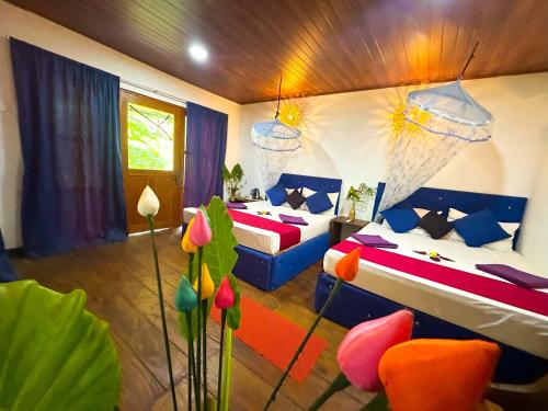 a bedroom with two beds and a basketball hoop at Nature Rest Ashored in Sigiriya