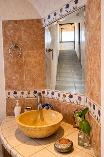 a bathroom with a wooden sink on a counter at Entre el sol y la luna in Taxco de Alarcón