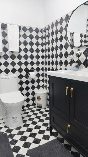 a bathroom with a black and white checkered floor at Le Noci Room 2203 in Ao Nang Beach