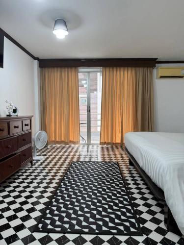a bedroom with a bed and a checkered floor at Le Noci Room 2203 in Ao Nang Beach