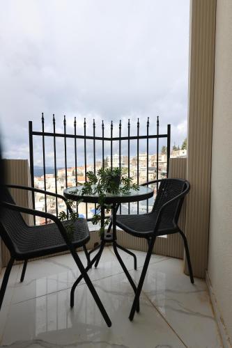 a table and chairs on a balcony with a view at ירושלים a in Safed