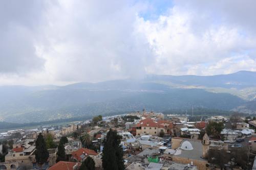 a view of a city with mountains in the background at ירושלים a in Safed
