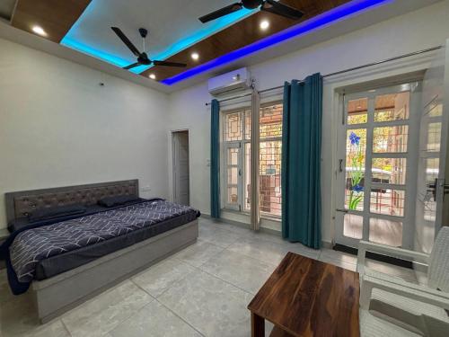 a bedroom with a bed and a ceiling fan at Greenvalley Homestay in Rāipur