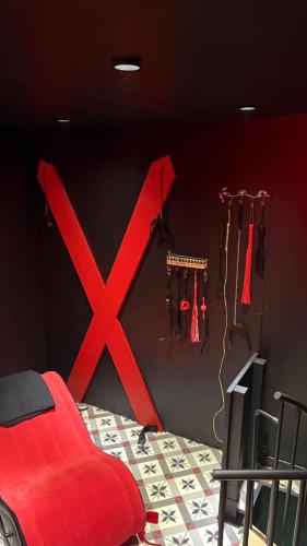 a bedroom with a red x on the wall at L'instant Désir love room jacuzzi in Ferrières