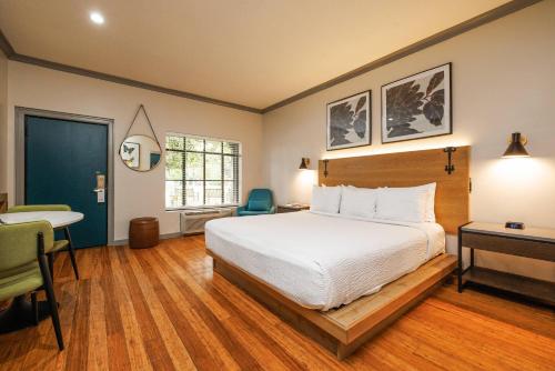 a bedroom with a bed and a desk and a chair at Inn Marin and Suites, an Ascend Collection Hotel in Novato