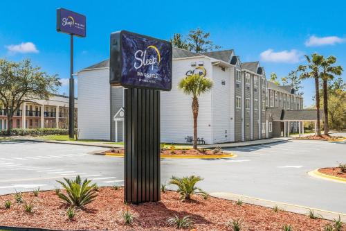 a sign on a pole in front of a building at Sleep Inn & Suites Tallahassee-Capitol in Tallahassee