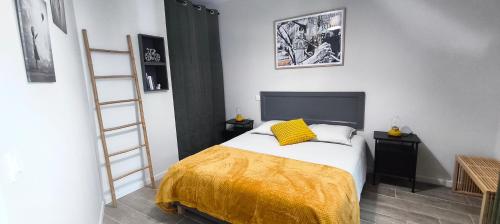 a bedroom with a bed with a yellow blanket at La Grange de Junas in Junas