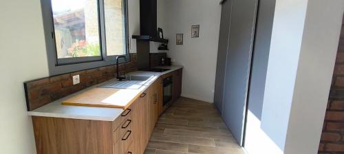 a kitchen with a sink and a window at La Grange de Junas in Junas