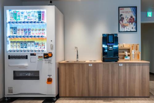 a vending machine next to a counter in a store at INA HOUSE Nijojo in Kyoto