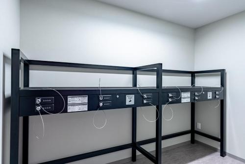a bunk bed with audio equipment in a room at INA HOUSE Nijojo in Kyoto