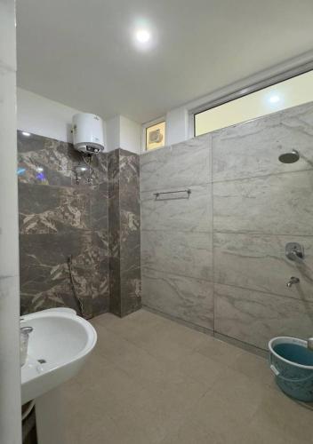 a bathroom with a shower and a sink and a shower at Greenvalley Homestay in Rāipur