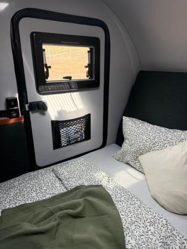 a bed in a small room with a window at Berg & See Hideaway in Mitterstein